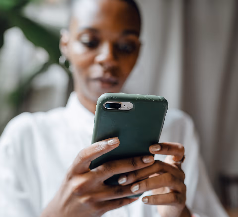 A woman reading a message on her phone